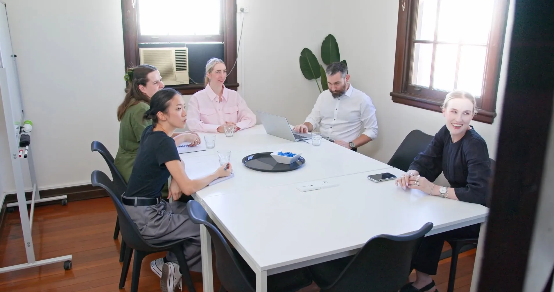 A group meeting around the Salt Space meeting table